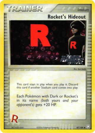 A Pokémon product titled "Rocket's Hideout (87/109) (Stamped) [EX: Team Rocket Returns]" from the Pokémon series. This uncommon Stadium Trainer card showcases a Team Rocket member in a dark uniform with a red "R" on their chest. The card text indicates it boosts HP for Pokémon with "Dark" or "Rocket's" in their names.