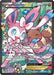 A Pokémon trading card featuring Sylveon EX (RC32/RC32) (Full Art) [Generations: Radiant Collection] with 170 HP from the Radiant Collection series. Set against a colorful, pastel background with Sylveon and Eevee, this Ultra Rare card showcases powerful attacks: Dress Up (30+) and Precious Ribbon (100). It includes various icons, text descriptions, and reflective elements.