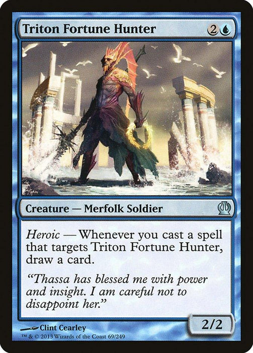 The image is of a "Magic: The Gathering" card named "Triton Fortune Hunter [Theros]". It costs 2 and a blue mana to cast. This Merfolk Soldier has a Heroic ability that lets you draw a card whenever you cast a spell targeting it. Illustrated by Clint Cearley, it has power/toughness of 2/2.