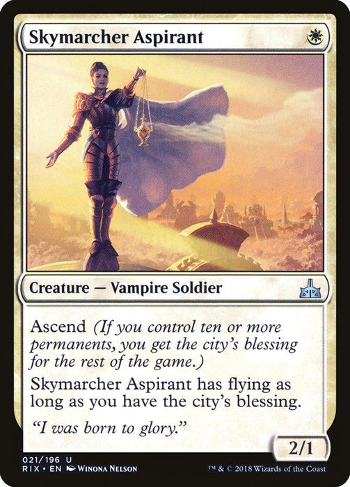 A Magic: The Gathering card from the Rivals of Ixalan set titled "Skymarcher Aspirant [Rivals of Ixalan]." It features a Vampire Soldier standing on a cliff, holding scales. The card has a white border and text box, with the ability "Ascend" and gains flying if the player has the city's blessing. The card stats are 2/1.