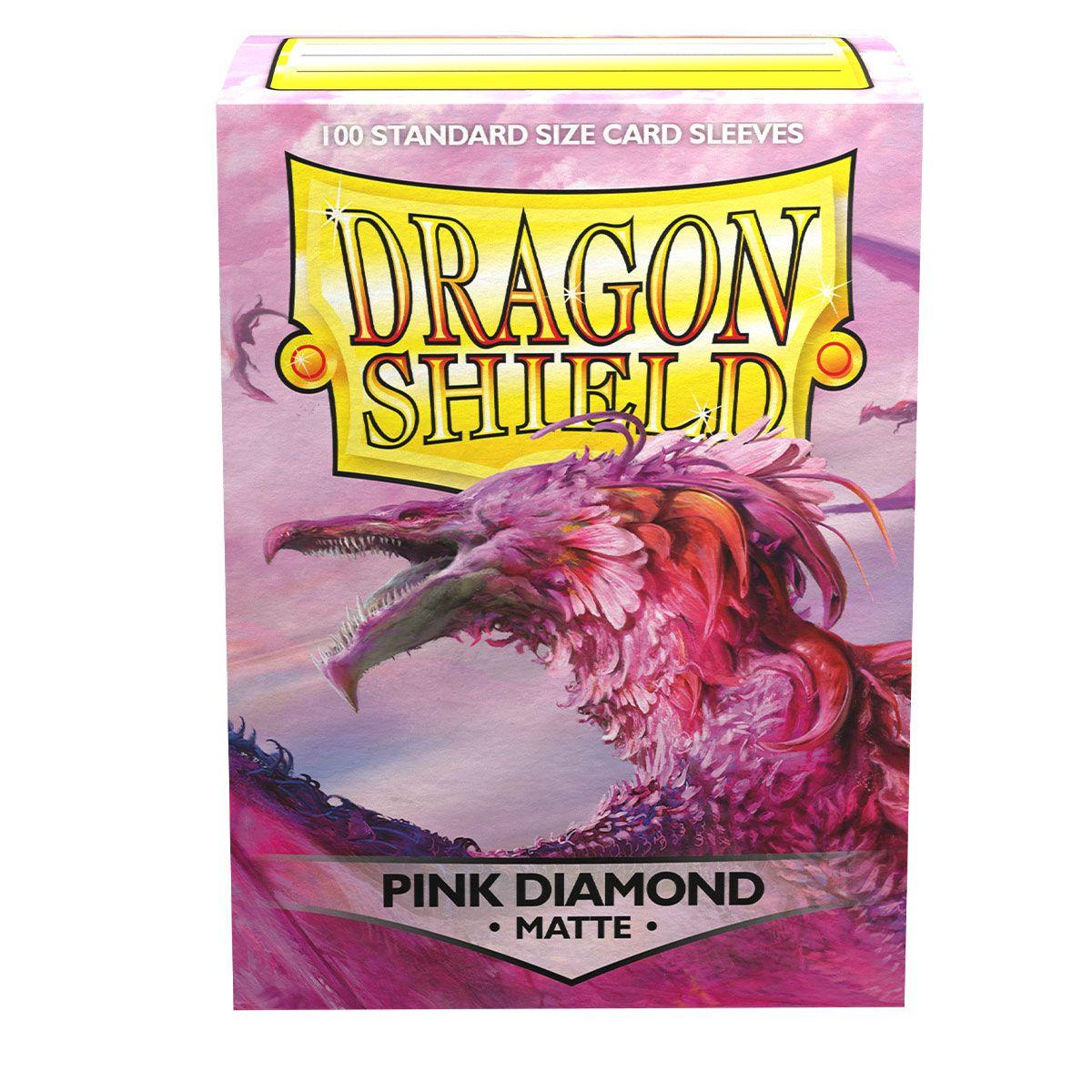 A package of Dragon Shield: Standard 100ct Sleeves - Pink Diamond (Matte) by Arcane Tinmen is depicted. The pink box features an illustration of a pink, feathered dragon with wings. The text on the box reads 