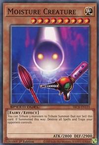 A Yu-Gi-Oh! trading card titled "Moisture Creature [SBCB-EN133] Common," featured in the Battle City Box. This ethereal, glowing blue Effect Monster with yellow eyes floats above a grid-patterned ground. Its ATK is 2800, and DEF is 2900. A Fairy/Effect type with specific summoning abilities, it destroys all spells and traps.

