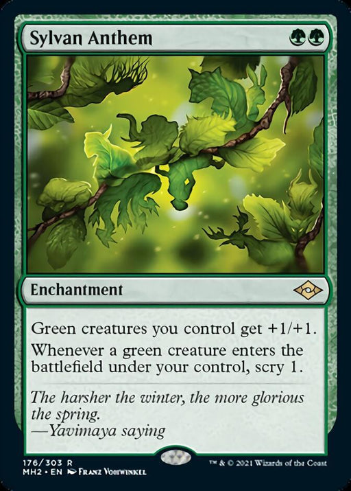A Magic: The Gathering product titled Sylvan Anthem [Modern Horizons 2] from the brand Magic: The Gathering. It depicts an enchantment with a green mana cost of two forest symbols. The illustration shows lush green leaves and branches illuminated by a mystical green glow. The card text grants bonuses to green creatures and allows scrying when they enter the battlefield.