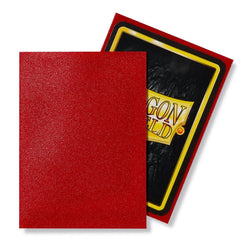 Two trading cards are displayed, one with a textured red back and the other partially showing a black back with a red border and central yellow rectangle labeled "Dragon Shield." Protected by Arcane Tinmen's Dragon Shield: Standard 100ct Sleeves - Ruby (Matte) for added durability.