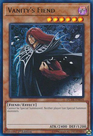 The image is of the "Vanity's Fiend [DUDE-EN034] Ultra Rare" Yu-Gi-Oh! trading card. This Ultra Rare card showcases a fiendish character with long red hair and dark, elaborate armor. The text reads: "Cannot be Special Summoned. Neither player can Special Summon monsters." It has 2400 ATK, 1200 DEF, and is