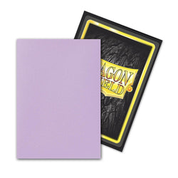 A Dragon Shield: Japanese Size 60ct Sleeve - Orchid (Dual Matte) by Arcane Tinmen, featuring a light purple front and dark textured back, overlaps another card. The second card's rugged back shows a yellow/silver "Dragon Shield" logo on black for superior protection.