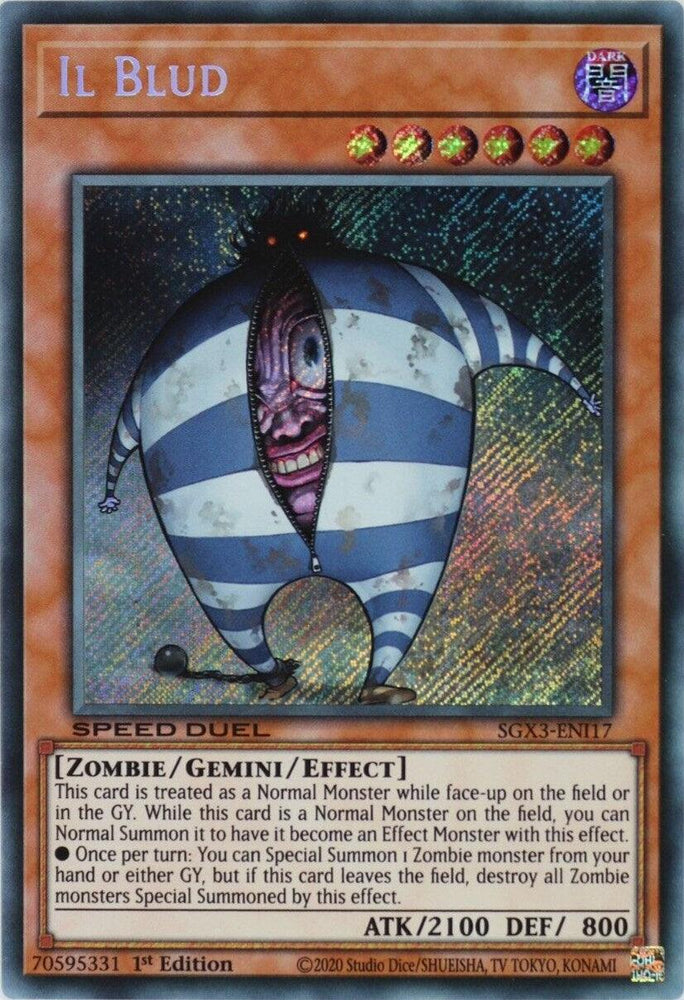 A "Yu-Gi-Oh!" trading card depicting the monster "Il Blud [SGX3-ENI17] Secret Rare." This creepy, egg-shaped zombie with striped blue and white patterns features spikes and a sinister grin. The Secret Rare card outlines its special Zombie/Gemini/Effect properties, attack (2100), defense (800), and Speed Duel GX capabilities.