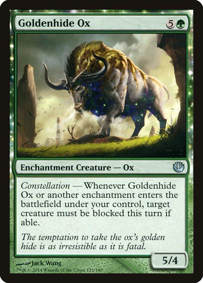 A Magic: The Gathering card from *Journey into Nyx* features Goldenhide Ox [Journey into Nyx]. The illustration depicts a large, glowing ox with golden fur and green horns walking through an enchanted forest. As an Enchantment Creature, it includes the 