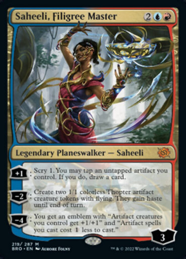 The image showcases the Magic: The Gathering card "Saheeli, Filigree Master [The Brothers' War]." Featuring Saheeli adorned in intricate jewelry and vibrant clothing, this Legendary Planeswalker with blue and red trim elegantly details her abilities, including creating Thopter tokens, with a loyalty of 3.