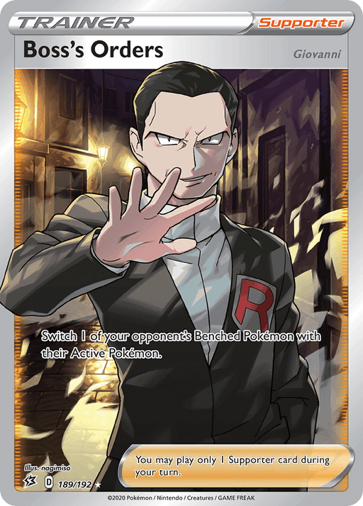 A Pokémon "Boss's Orders (189/192) (Giovanni) [Sword & Shield: Rebel Clash]" card from the Rebel Clash series featuring Giovanni in a dark suit with a red "R" emblem. He stands assertively in a dim alleyway, hand extended. The Ultra Rare card’s text reads, "Switch 1 of your opponent’s Benched Pokémon with their Active Pokémon.