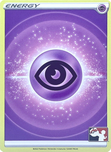 The Pokémon Psychic Energy card from the Prize Pack Series Two displays a captivating design, highlighted by a central eye symbol amidst a radiant energy field adorned with sparkles, all set against a gradient purple backdrop. The card features the word "Energy" at the top and proudly bears the Prize Pack Series Two logo in the bottom right corner.