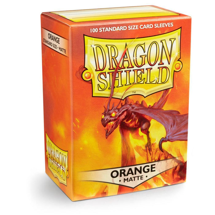 A box of Dragon Shield: Standard 100ct Sleeves - Orange (Matte) by Arcane Tinmen, containing 100 matte sleeves. The orange matte finish box features an illustration of an orange dragon against a fiery background. Text on the box reads "DRAGON SHIELD" and "ORANGE MATTE.