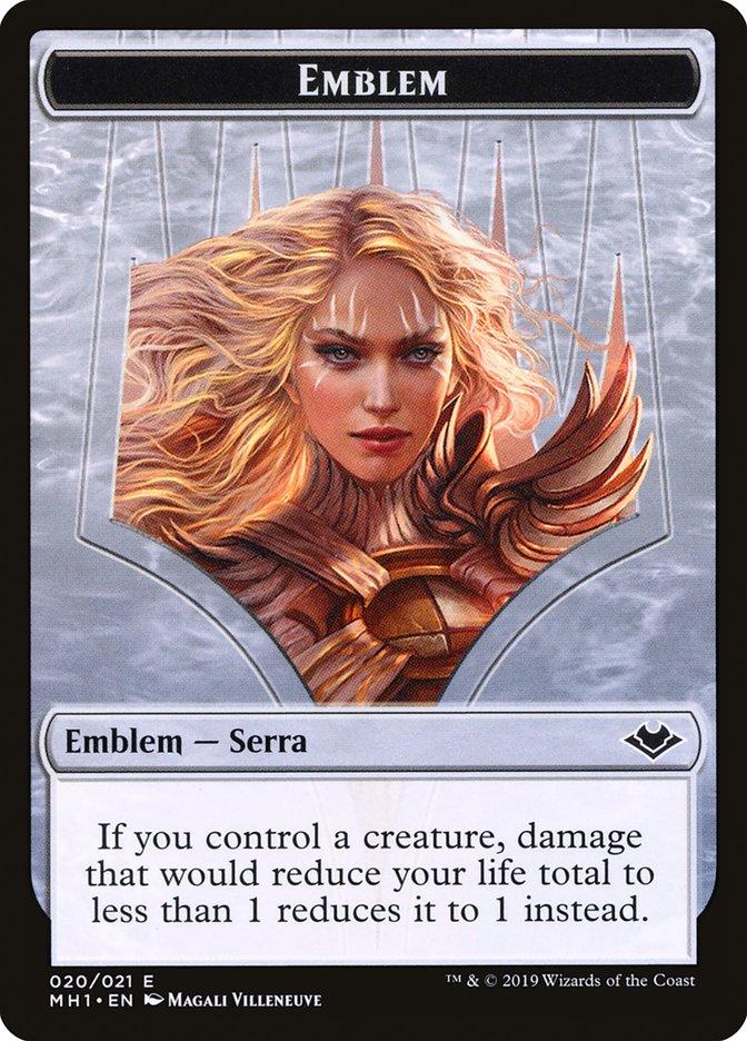 A Magic: The Gathering card titled "Serra the Benevolent Emblem [Modern Horizons Tokens]" showcases a powerful female figure with flowing blonde hair, adorned in golden armor. The card text reads, "If you control a creature, damage that would reduce your life total to less than 1 reduces it to 1 instead.