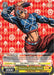 A Promo Card featuring a stylishly dressed man in a dynamic pose against a red, geometric background. He wears a blue outfit with intersecting white lines and a red headpiece. The card, inspired by Bushiroad's Pioneer of Fate, Mista (JJ/S66-E101 PR) [JoJo's Bizarre Adventure: Golden Wind], includes attributes with text in both English and Japanese, and showcases stats, abilities, and a description below.
