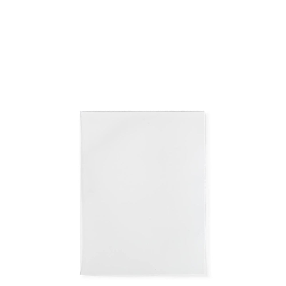 A close-up image of a pristine, clear Dragon Shield: Standard Size 100ct Inner Sleeve - Perfect Fit (Clear 'Sanctus') by Arcane Tinmen placed against a white background. The sleeve has a smooth texture with sealed edges and appears to be empty. The minimalist composition highlights the inner sleeve without any surrounding distractions, reminiscent of clean, white envelopes used for card protection.