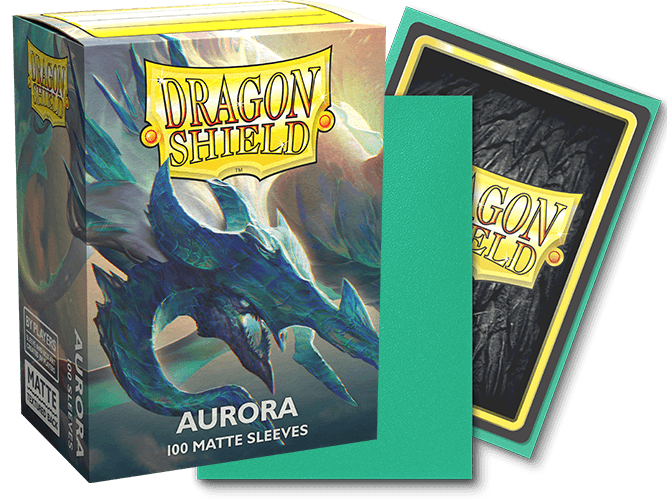 A box of Arcane Tinmen Dragon Shield: Standard 100ct Sleeves - Aurora (Matte), displaying a dragon with aurora-like colors, is shown. Next to the box, a sleeve faces forward, showing the Dragon Shield logo, while another sleeve, green on the back, lies partially in front. Text on the box reads "100 MATTE SLEEVES.