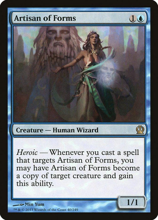 A Magic: The Gathering card titled "Artisan of Forms [Theros]" from the Theros plane. It features a female human wizard with light emanating from her hand, standing before a giant stone face. The card costs 1 colorless and 1 blue mana, and is a 1/1 creature with the Heroic ability to become a copy of any target creature.