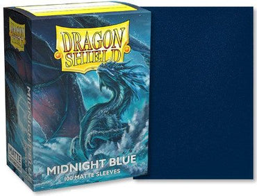 A pack of 100 Arcane Tinmen Dragon Shield: Standard Sleeves in "Midnight Blue" (Matte) lies next to a box illustrated with a blue dragon among stormy clouds, offering excellent protection with dark blue, matte-finished sleeves.