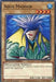 A Yu-Gi-Oh! card titled "Aqua Madoor [SBCB-EN002] Common," featured in the Battle City Box. This Normal Monster depicts a blue-haired, humanoid figure with a pointed hat and a long green cloak, holding a staff. With an ATK of 1200 and DEF of 2000, the wizard wields water to fend off enemies in Speed Duels.